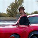 Client Amara portrait next to her modified Nissan GTR